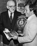 Gus Goutouski presenting plaque to Otto Jelinek, M.P.   Gus Goutouski was Regional councillor 1979-1980.