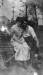 Young man and woman sitting on bench