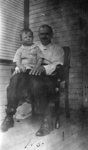 Man with young boy sitting on knee