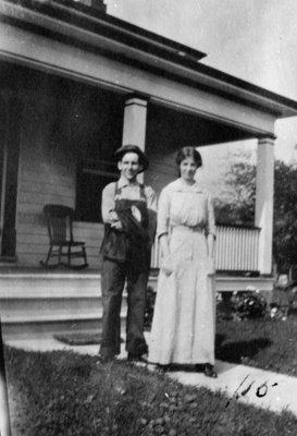 Man and woman standing in front of house