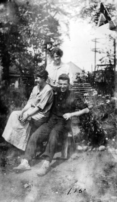 Two young ladies and one young man in rustic setting