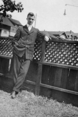 Young man leaning on a fence