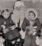 Santa Claus holding Susan Carruthers and friend