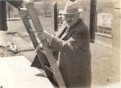 P. L. Robertson inspecting roof