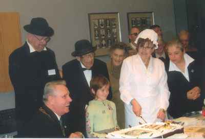 New Years Levee, 2007. Mirella Marshall cutting the anniversary cake.