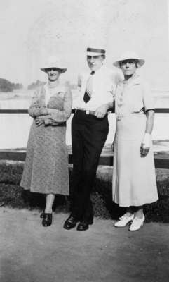 Man and two women standing by rail