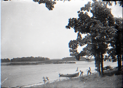 2 men pulling boat to shore