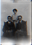 Woman Standing Behind 2 Seated Men in Posed Photo