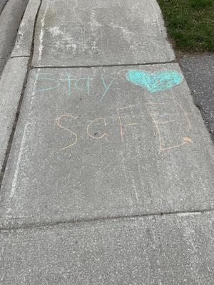 Sidewalk chalk message: Stay safe