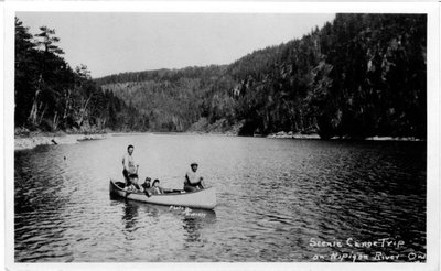 Native guides in canoe with passengers