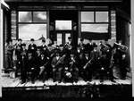 Band posed outside storefront, Norwich