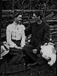 Couple sitting in garden with hats, Norwich