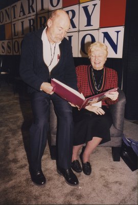 Robin Dunbar, OLTA president 2000, shares a book at the OLA expo stage