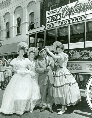 Mayor Anderson posing with three women from the Official Party during Oakville's Centennial celebration