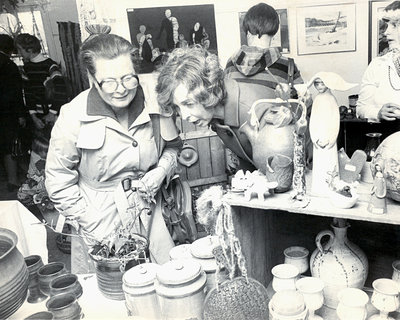 Two ladies looking at pottery