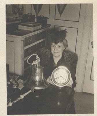 Oakville resident Mrs. Marlatt displays ship's bell and chronometer