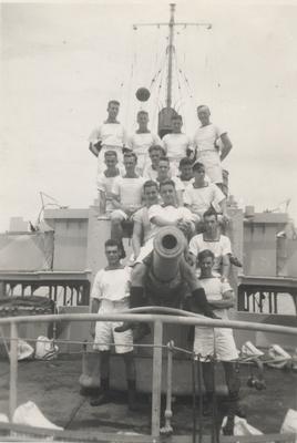 HMCS Oakville ratings pose on 4 inch gun