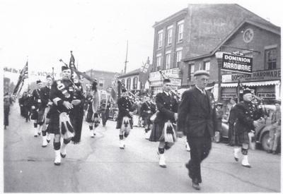 The Lorne Scots Pipe Band, Veterans, and Boy Scouts marched in the parade to celebrate the christening ceremony of the H.M.C.S. Oakville.