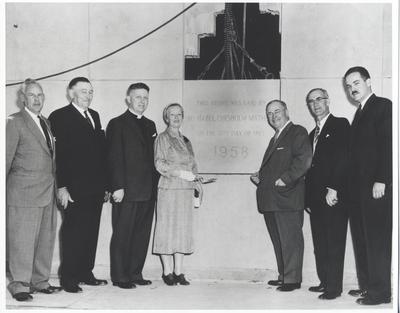 Hazel Chisholm Mathews getting ready to place the mortar on the commemorative wall for the new Post Office