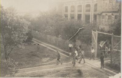 People exiting the grounds of a building