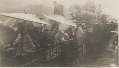 Chinese people taking the train on a rainy day