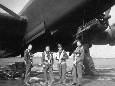 Flight Lieutenant John Cooper, Pilot (right) standing under a Halifax III Bomber Aircraft.