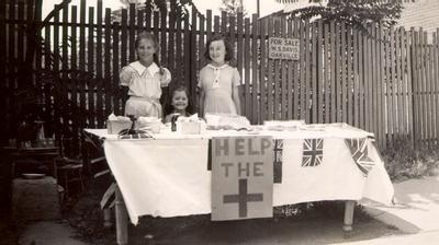 Oakville residents of all ages firmly supported the war effort. Patricia and Elizabeth Grammell and Jean Hunt on Colborne Street raising money for the Red Cross during the Second World War.