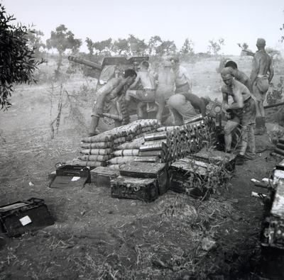 Men of the Royal Canadian Artillery fire a 25-pounder at enemy positions in Nissoria during the invasion of Sicily in 1943. Gunner Jim Gibb from Oakville is centre right of the gun.