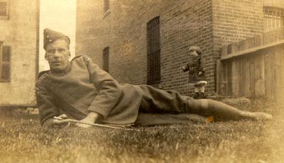 James Byron Kelley in Royal Flying Corps uniform with his younger brother Roy Kelley behind a tailor's shop north side, Lakeshore Road, Oakville.