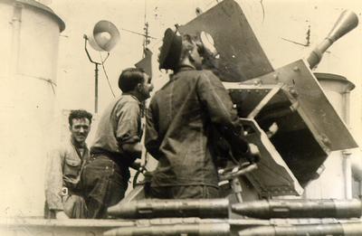 Gunners with aft pom-pom gun on corvette