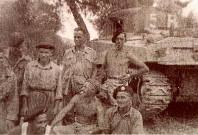 Corporal Joe Turnbull (bottom right), Crew Commander with 12th Canadian Tank Regiment - A Squadron, with shot-out tank &quot;Amazing.&quot;