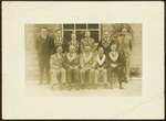 Eleven Unidentified Men posing in front of a Building