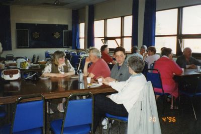 Louis and Rosemary Kirby talking to others at a table over lunch.