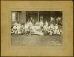Unidentified Group of People in Front of a Large Brick House