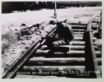 Railway Construction - A Worker Grinding a Wax Welded Joint