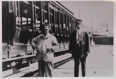 Two Rail Workers in Front of an Open Side Car