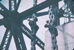 Two Men Working on Chains of a Vertical Lift Bridge