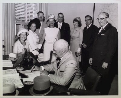 Lt. Gov. Earl Rowe signs a guest book at City Hall