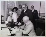 Lt. Gov. Earl Rowe signs guest book at City Hall