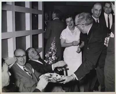 Group photograph of city employees and members at a reception