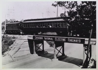 Tram car on a bridge passing over a highway