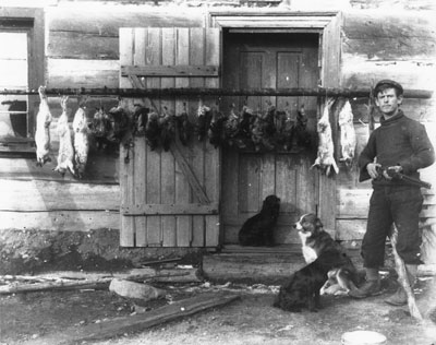 Hunter with Kill of Hares and Grouse