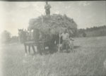 Ed Sohm and Henry Erven, wagon with hay, circa 1933