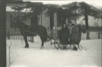 Two women and sleigh in front of Harper's House, Sundridge, circa 1928