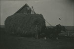 Two men and one woman, with a wagon loaded with hay, Sohm Farm, circa 1930