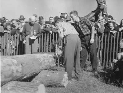 Man Chainsawing a Log,  South River Agricultural Society Fall Fair, circa 1950