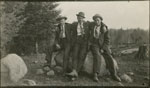 Fred Sohm, Ed Russell & Fred Ulrich Sitting on a Rock, circa 1920