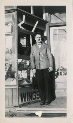 Man Standing in a Store Doorway