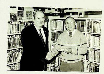 Photograph of Legion member handing over a donation to the Library, Stirling, ON