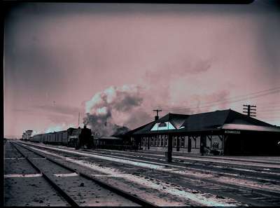 CPR station, train travelling west, Swift Current, c. 1951.